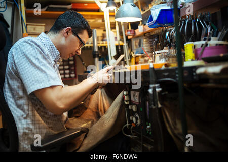 Goldsmith lavorando sul suo banco di lavoro Foto Stock