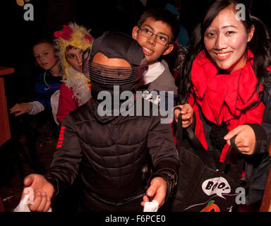 Asiatici e Americani bianchi adolescenti e bambini costume Halloween Trick or treaters. St Paul Minnesota MN USA Foto Stock