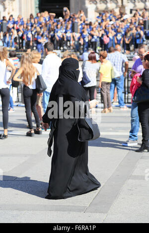 Donna orientale, indossando un nero burqa, la folla di gente, Piazza del Duomo, Milano, Lombardia, Italia Foto Stock