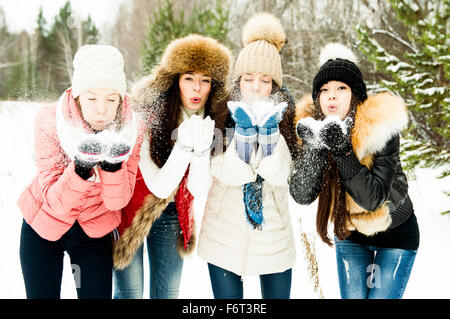 Ragazze caucasica soffiando la neve da mani Foto Stock