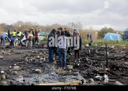 Calais, Francia. 22 Novembre, 2015. Supporto dei rifugiati tra le macerie di bruciato nella nuova giungla campo profughi. 3 persone sono stati ricoverati in ospedale e più di cinquanta capanne e tende hanno distrutto da un incendio durante la notte nella parte eritrea della nuova giungla campo in Calais. La causa del fuoco non è stata determinata. © Michael Debets/Pacific Press/Alamy Live News Foto Stock