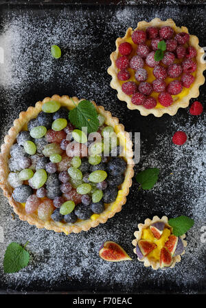 Estate Crostate di frutti di bosco su nero, cibo vista superiore Foto Stock