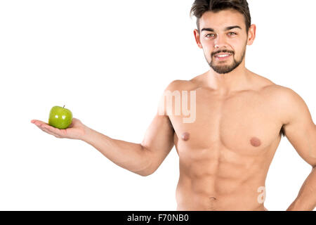 Bello e montare il giovane con un Apple isolato in bianco Foto Stock