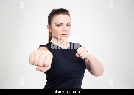 Ritratto di una donna grassa in sports wear colpendo in telecamera isolata su uno sfondo bianco Foto Stock