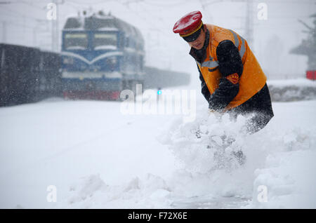 (151124) -- ZHENGZHOU, nov. 24, 2015 (Xinhua) -- Un personale ferroviario cancella neve a Xinxiang stazione ferroviaria in Xinxiang, centrale cinese della Provincia di Henan, nov. 24, 2015. Nevicata a partire da lunedì ha causato alcune tratte ferroviarie ritardo nella Provincia di Henan. (Xinhua/Wang Huan) (DHF) Foto Stock