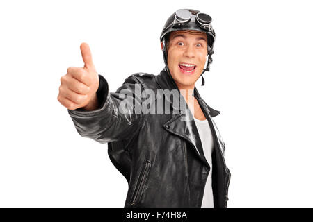 Gioiosa giovane biker con nero giacca di pelle dando un pollice in alto e guardando la telecamera isolata su sfondo bianco Foto Stock