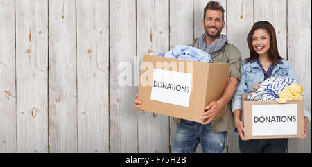 Immagine composita del ritratto di una felice coppia giovane con vestiti donazione Foto Stock