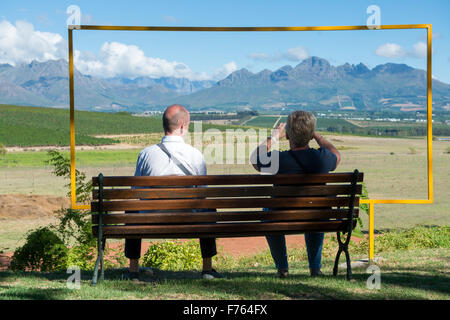 Sud Africa - uomo e donna seduta su un banco di lavoro guardando la gamma della montagna. Foto Stock