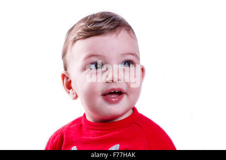 Poco felice ragazzo di un anno di età su sfondo bianco Foto Stock