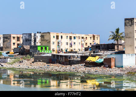 La povertà del Terzo mondo lifestyle: poveri baraccopoli, blocchi di appartamenti sulle rive del inquinato Adyar estuario del fiume di Chennai, nello Stato del Tamil Nadu, nell India meridionale Foto Stock