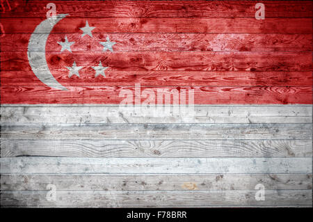 Un vignettato immagine di sfondo della bandiera di Singapore su assi di legno di una parete o di pavimento. Foto Stock