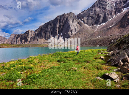 Donna lascia il grande zaino sullo sfondo di una natura selvatica in Siberia orientale Foto Stock