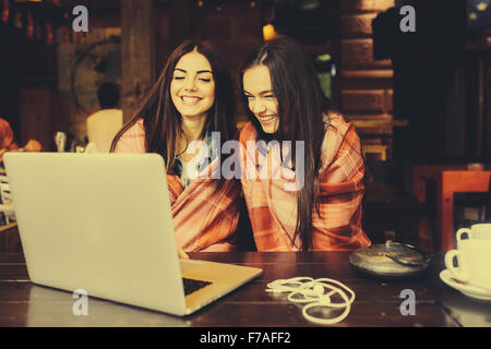 Due ragazze guardare qualcosa in laptop Foto Stock