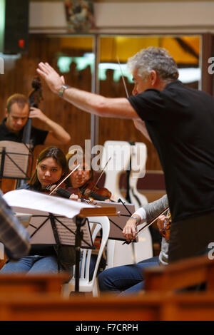 Rehearins con un conduttore e suona il violino in una prova Foto Stock