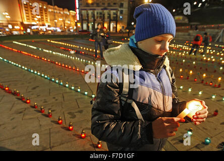 Kiev, Ucraina. 28 Nov, 2015. Ragazzo ucraino assistere ad una cerimonia commemorativa in Piazza Indipendenza. Gli ucraini accendono le candele per contrassegnare un giorno della memoria per le vittime del Holodomor nel 1932-1933. Il Holodomor era un uomo fatto carestia provocata dal dittatore sovietico Josef Stalin. Il risultato fu la morte di più di cinque milioni di Ucraini. © Vasyl Shevchenko/Pacific Press/Alamy Live News Foto Stock