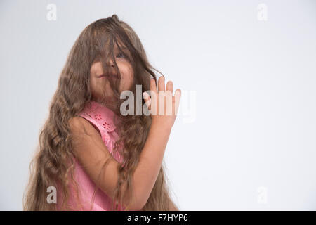 Ritratto di una bambina divertendosi isolato su uno sfondo bianco Foto Stock