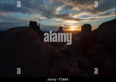 Tramonto dietro buttes nella Monument Valley, Utah, Stati Uniti d'America Foto Stock