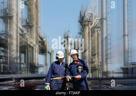 Il petrolio e il gas dei lavoratori all'interno della grande industria di raffinazione Foto Stock