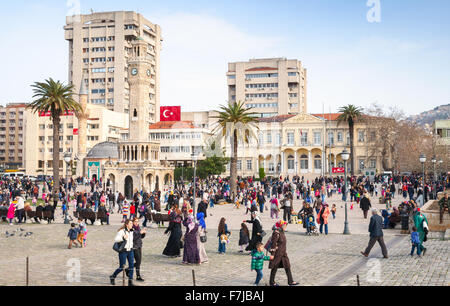 Izmir, Turchia - 5 Febbraio 2015: piazza Konak con persone a piedi, centrale piazza della città con la torre dell orologio e antica moschea Foto Stock