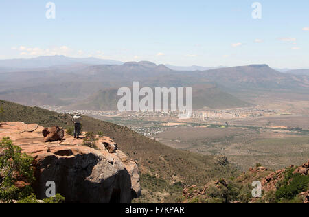 Un turista guardando verso il basso sulla grande Karoo città di Graaff-Reinet da Camdeboo Parco Nazionale Foto Stock