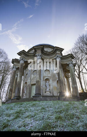 Luce del sole di mattina proveniente attraverso le colonne del Tempio di Apollo a Stourhead, Wiltshire, su una gelida giornata di gennaio. Foto Stock