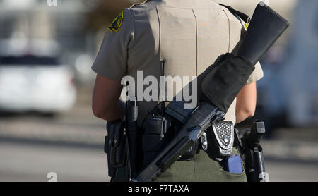 San Bernardino, Stati Uniti d'America. 2° dic, 2015. Un poliziotto di pattuglie vicino la scena di una sparatoria a San Bernardino città del sud della California, negli Stati Uniti il 2 dicembre, 2015. Almeno 14 persone sono state uccise e 14 altri feriti in una sparatoria mercoledì a San Bernardino città della California Meridionale e fino a tre tiratori sono ancora attivi, la polizia ha detto. Credito: Yang Lei/Xinhua/Alamy Live News Foto Stock