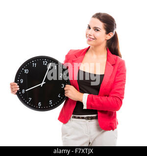 Business donna tenendo un grande orologio da mani Foto Stock