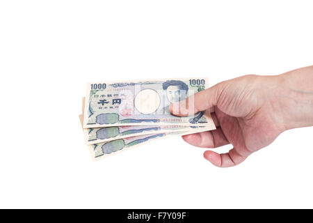 Giapponese Yen denaro in man mano isolato su bianco Foto Stock