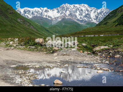 Monte Shkhara visto da Zhibiani - uno dei quattro villaggi comunità chiamata Ushguli superiore nella regione di Svanetia, Georgia Foto Stock