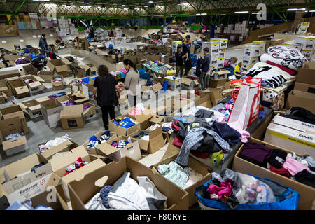 In arrivo dei rifugiati in Dortmund Keuning house i rifugiati di volontari sono alimentati con cibo e vestiario. Foto Stock