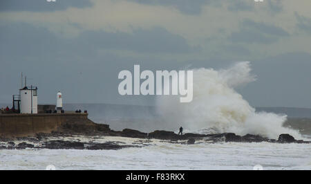 Porthcawl, Wales, Regno Unito, 5 dicembre 2015. Un fotografo si mette in pericolo per catturare le onde enormi battendo il Galles del Sud Costa. Credito: Tom Guy/Alamy Live News Foto Stock