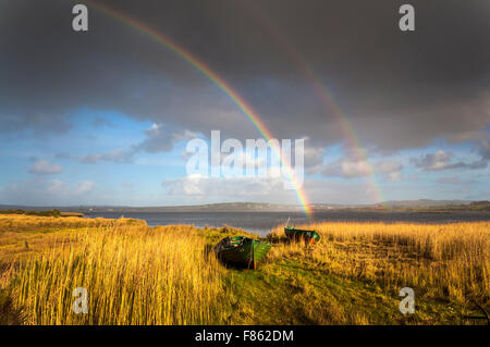 Ardara, County Donegal, Irlanda Meteo. Il 6 dicembre 2015. Dopo due giorni di pioggia incessante durante la tempesta Desmond un arcobaleno appare più di canneti e barche di pescatori sulla costa occidentale. Credito: Richard Wayman/Alamy Live News Foto Stock