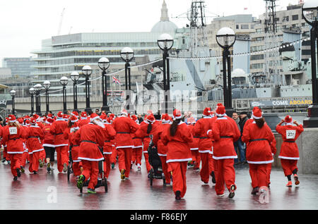 Santa nella città è uno di Londra più recente Christmas Santa corre con il suo inizio e fine al di fuori di City Hall. Il percorso ha preso runner per il Tower Bridge e intorno alla Torre di Londra, Regno Unito Foto Stock