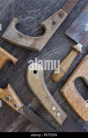 Impugnature in legno di vecchie seghe / old handsaws dettagli su sfondo di legno Foto Stock