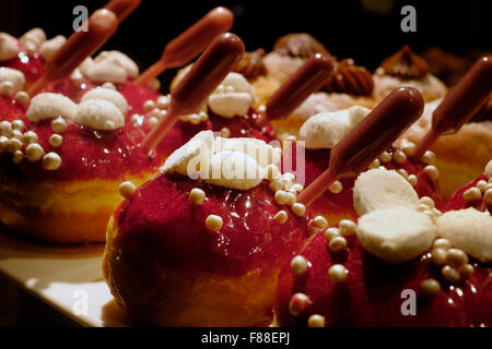 Elegantemente tradizionale Sufganiyot fritte ciambella rotonda mangiato durante la festa ebraica di Hanukkah, la festa delle luci Foto Stock