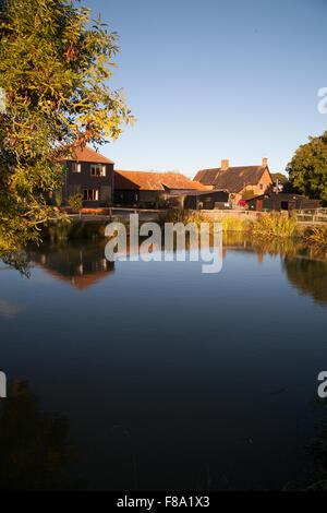 Agriturismo Cottage riflessa in un grande stagno a Cratfield Suffolk in Inghilterra Foto Stock