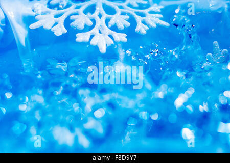 Il simbolo del fiocco di neve si scioglie in acqua bokeh astratto sfondo stagionali Foto Stock