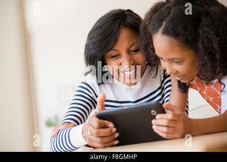 Madre e figlia con tavoletta digitale Foto Stock