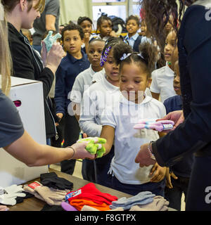 Detroit, Michigan STATI UNITI D'AMERICA. Il 9 dicembre 2015. Bambini a Dossin scuola elementare ricevono i guanti da una carità denominati muffole per Detroit. La carità è la distribuzione di muffole per 26.000 Detroit pubbliche scuole elementari di studenti; la maggior parte sono stati donati da dipendenti di Chrysler Fiat Automobiles. Credito: Jim West/Alamy Live News Foto Stock