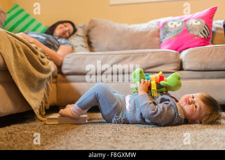 Il bambino e la madre figlia rilassante nella stanza vivente Foto Stock