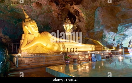 Thailandia - Phang Nga, Wat Suwan Kuha tempio nella grotta, inclinabile Golden statua del Buddha Foto Stock