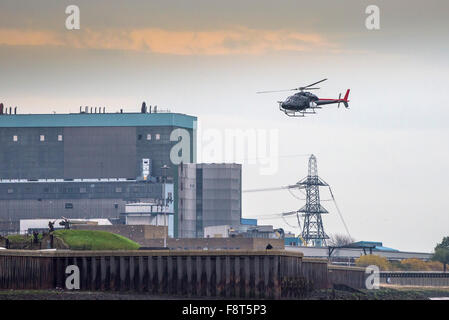 Un elicottero sorvola Tilbury B Power Station sulle rive del fiume Tamigi. Foto Stock