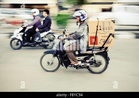 Il panning fotografia immagine di velocizzare i motociclisti in una città indonesiana Foto Stock