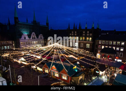 Lubecca, Germania. Decimo Dec, 2015. Visitatori passeggiata attraverso gli illuminati mercatino di Natale di fronte al municipio di Lubecca, Germania, 10 dicembre 2015. Foto: Daniel Bockwoldt/dpa/Alamy Live News Foto Stock