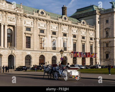 Carrello a Heldenplatz nella parte anteriore del vecchio Palazzo di Hofburg a Vienna, in Austria, il patrimonio mondiale Foto Stock