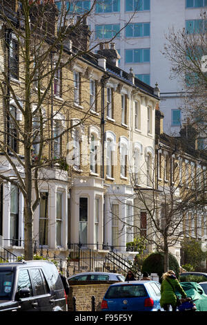 Hammersmith, Londra. Vista di case a schiera in una strada residenziale di Hammersmith. Automobili parcheggiate lungo la strada. Foto Stock