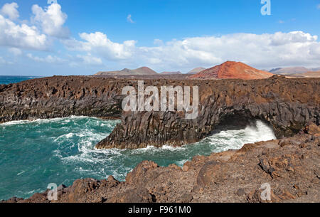 Costa rocciosa di Los Hervideros, paesaggio vulcanico, Fire montagne del Parco Nazionale di Timanfaya dietro, Lanzarote, Isole Canarie Foto Stock