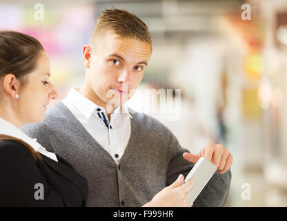 Imprenditore e imprenditrici avente un incontro di shopping mall. La donna è incinta. Foto Stock