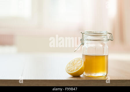 Dettaglio del miele e limone con sunny interno di una casa in background Foto Stock