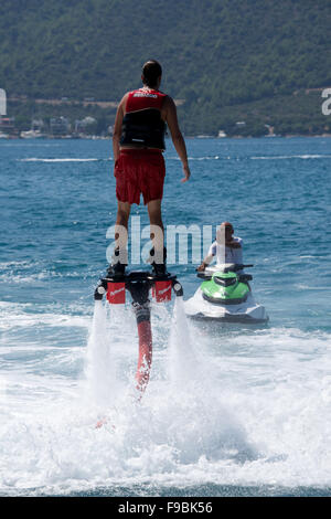 Flyboarder insegnata da uomo su Jet Ski Foto Stock